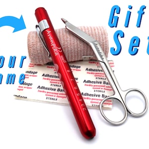 May include: A red first aid kit with a bandage roll, a pair of scissors, and a red pen-shaped flashlight. The kit is labeled "Avantika" and includes the text "Gift Set".