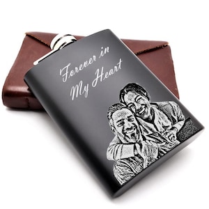 May include: Black metal flask with a personalised engraving of two people and the text "Forever in My Heart".