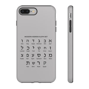 May include: A gray iPhone case with a black border and a white graphic of the Hebrew alphabet with English translations. The text reads "MODERN HEBREW ALEPH BET".