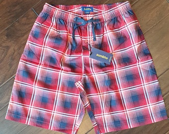 May include: Red and blue plaid pajama shorts with a drawstring waist and a button closure. The shorts have a tag that says "aumbho".