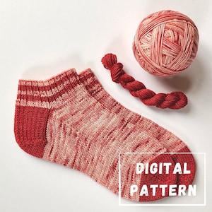 May include: A pair of red and white striped knitted socks with the text "DIGITAL PATTERN" on the heel. The socks are lying on a white surface next to a ball of red and white yarn.
