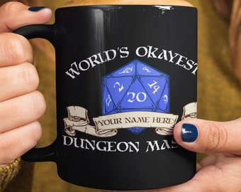May include: Black ceramic mug with a white design featuring a blue twenty-sided die and the text "World's Okayest Dungeon Master".