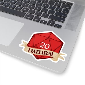 May include: A red D20 die sticker with the number 20 and the word "natural" on a banner. The sticker is on a laptop.