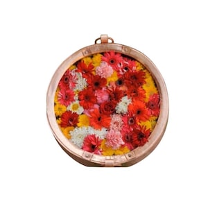 May include: A copper bowl filled with a variety of colorful flowers, including red, pink, yellow, and white.