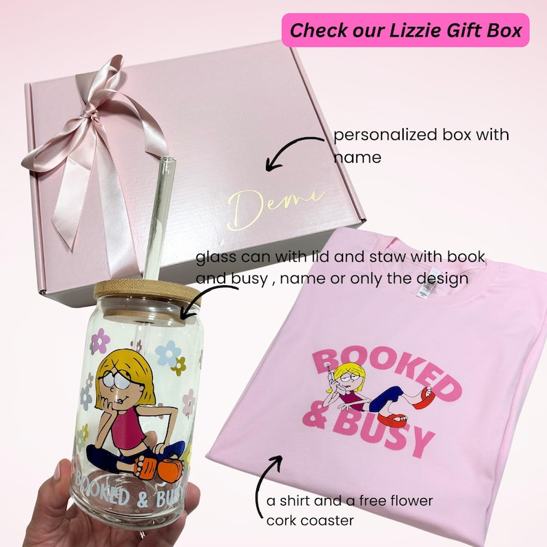 May include: A pink gift box with a white ribbon and the name "Demi" written on it. The box contains a glass can with a lid and straw, a pink t-shirt with the text "BOOKED & BUSY" and a cartoon illustration of a woman on a phone, and a cork coaster.