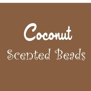May include: A brown background with white text that reads "Coconut Scented Beads".