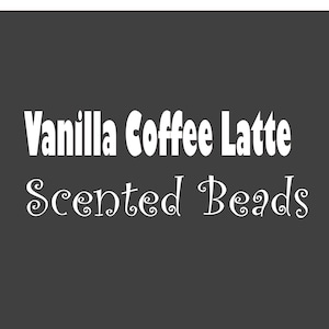 May include: Vanilla Coffee Latte scented beads. These beads are white and have a whimsical font.