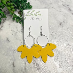 May include: Yellow flower-shaped earrings with silver hoops. The earrings are made by Jaggie Designs by Jo Gray.