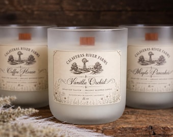 May include: Three frosted glass candles with wooden wicks. Each label features the Calaveras River Farms logo, a windmill illustration, and text including Vanilla Orchid, Coffee House, or Maple Pancakes, plus 16 oz and hand poured in Linden, California.