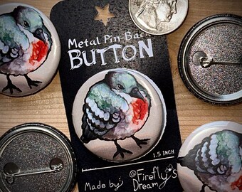May include: Metal pin-back buttons with a watercolour illustration of a bird with a red breast, grey and blue feathers, and black legs. The buttons are 3.8 cm in diameter. The card reads "Metal Pin-Back Button".