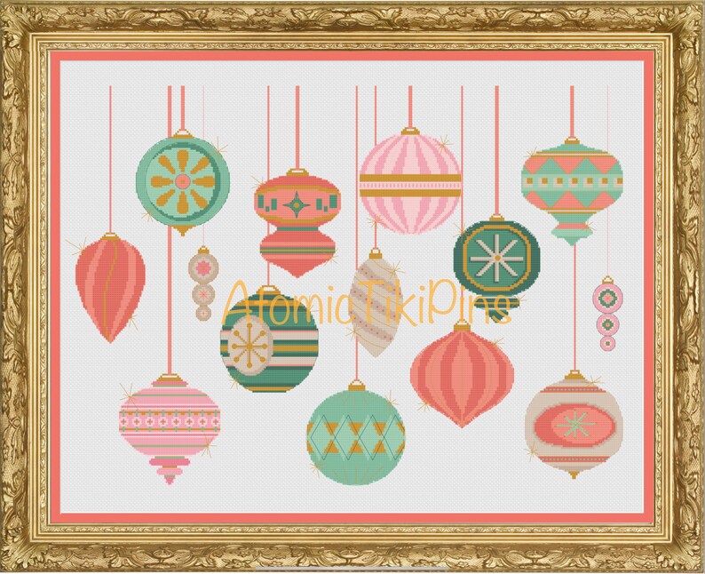 May include: A framed cross-stitch artwork featuring a collection of hanging ornaments in shades of pink, teal, and gold. The ornaments have various geometric and striped patterns. The artwork is set against a white background with a pink border.
