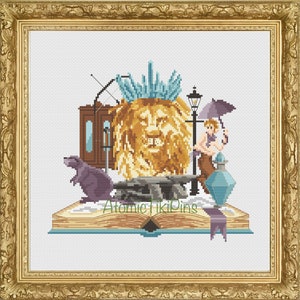 May include: Cross-stitch artwork featuring a lion's head, a rat, a lamppost, and a figure with an umbrella, all set on an open book. The artwork includes the text "Atomic Tiki Pins". The color palette includes gold, brown, blue, and purple.