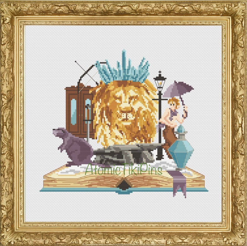 May include: Cross-stitch artwork featuring a lion's head, a rat, a lamppost, and a figure with an umbrella, all set on an open book. The artwork includes the text "Atomic Tiki Pins". The color palette includes gold, brown, blue, and purple.