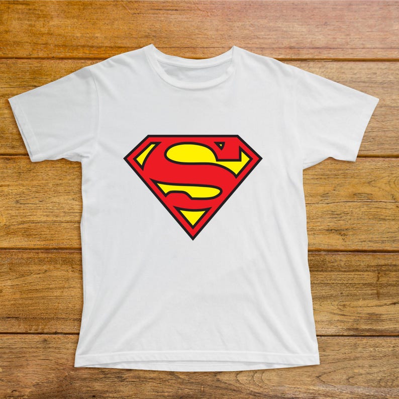 May include: White t-shirt featuring the Superman logo. The logo is a red and yellow diamond shape with a stylized "S" in the center. The shirt is made of a soft, lightweight material.