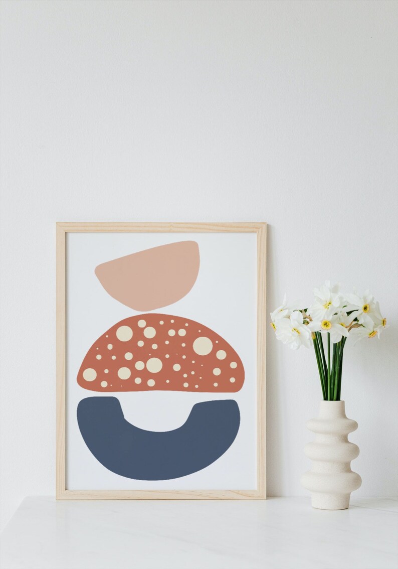May include: A framed abstract print with three overlapping shapes in shades of pink, red, and blue. The red shape is dotted with white circles.