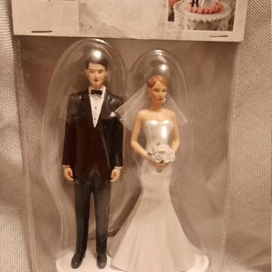 Modern Wilton Wedding Cake Topper With Veil. Beautiful Bride white dress with veil and Groom black suit