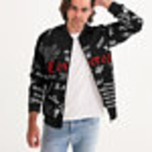 May include: A black bomber jacket with a colorful all-over print of various words and phrases.