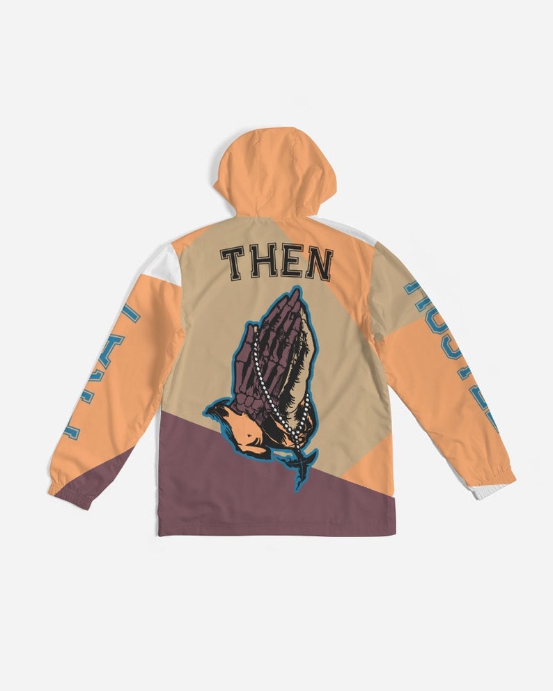 May include: A multi-coloured hooded jacket with a praying hands graphic and the word "THEN" printed on the back. The jacket has a white, orange, brown, and purple colour scheme.