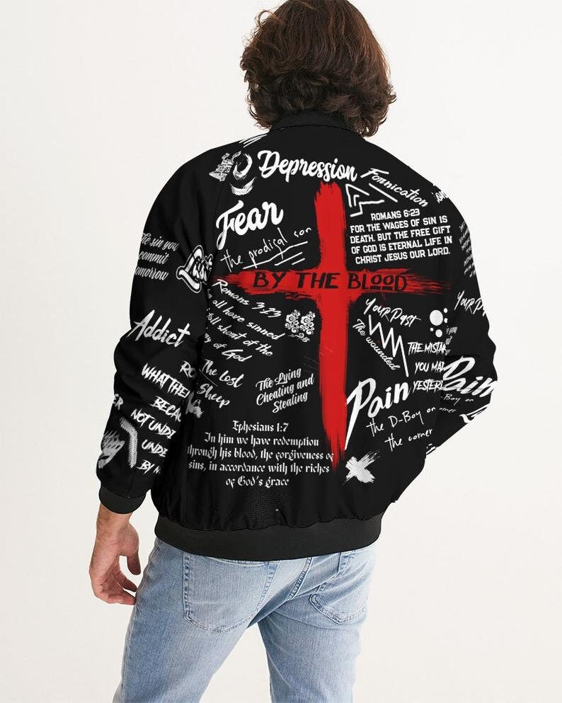 May include: Black bomber jacket with a red cross and white text. The text includes the words "Fear", "Depression", "By the Blood", "Pain", "The Lost", "The Lying and Cheating and Stealing", and "Your Past".