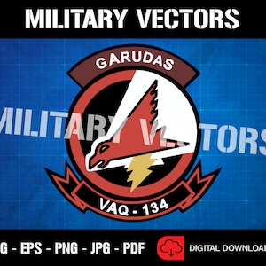 May include: A red, white, and black military insignia with a red bird and lightning bolt. The insignia is surrounded by a white circle with the text "GARUDAS" in black and "VAQ-134" in black.