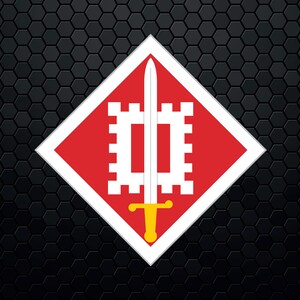 May include: A red diamond-shaped patch with a white sword and a white castle design. The sword has a gold handle.