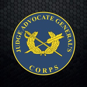 May include: A blue circle with the text "JUDGE ADVOCATE GENERAL'S CORPS" in yellow lettering. A crossed sword and quill are centered in the circle, surrounded by a yellow laurel wreath.