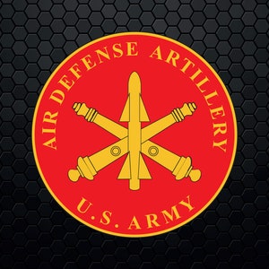 May include: A red circle with the words "Air Defense Artillery U.S. Army" around the edge. Inside the circle is a gold missile with two crossed cannons.
