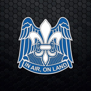 May include: A blue and white emblem with a fleur-de-lis and wings, with the text "IN AIR, ON LAND" below.