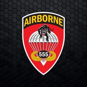 May include: A red, white, and yellow military patch with the word "AIRBORNE" in yellow letters. A black panther is depicted jumping out of a parachute with the number "555" in a white circle.