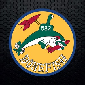 May include: A yellow circle with a blue border and the text "BONEFISH" in a stylized font. Inside the circle is a green and white cartoon fish with a red missile in its mouth. The number "582" is on the fish's head.