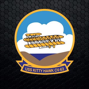 May include: A yellow and blue circular emblem with a yellow airplane flying over a brown and blue landscape. The text "USS KITTY HAWK CV-63" is below the emblem.