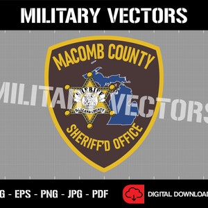 May include: A brown and gold sheriff's badge with the text "Macomb County Sheriff's Office" and a five-pointed star with the text "Sheriff" and "Oakland County".