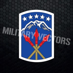 May include: A blue and white military unit patch with five white stars and a mountain range in the centre. Three crossed spears with red tips are in front of the mountain range.