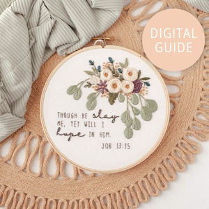 May include: Embroidered hoop art with white flowers and green leaves. The text reads "Though he slay me, yet will I hope in him. Job 13:15".