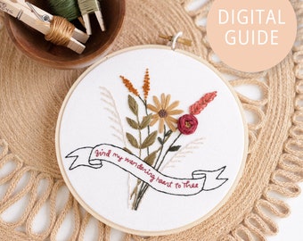 May include: Embroidered hoop art with a floral bouquet and a banner that reads "Find my wandering heart to thee".