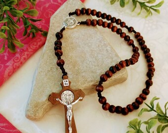 Wooden Catholic rosary with Saint Benedict medals.