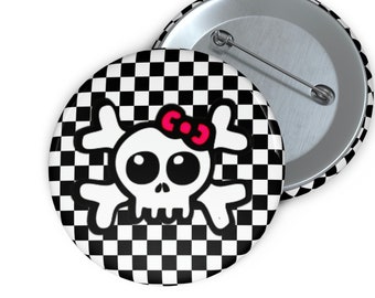 May include: A black and white checkered button with a white cartoon skull with pink bow on top.