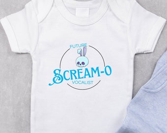May include: White baby onesie with a blue circle graphic featuring a skull with bunny ears and the text "FUTURE CREAM-O VOCALIST".