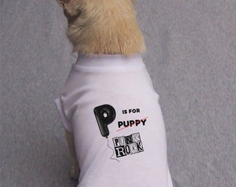 May include: A white dog shirt with a black letter "P" balloon and the text "is for puppy" with a line through "puppy" and the text "punk rock" in a black box.