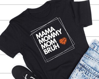 May include: Black t-shirt with a white graphic that says "Mama Mommy Mom Bruh" with a basketball in a heart shape.