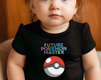 May include: A black baby bodysuit with the text "FUTURE POKEMON MASTER" in rainbow colors above a red, white, and black Pokeball graphic. The baby is looking directly at the camera.