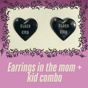 May include: A pair of black heart-shaped earrings with the text "ELDER EMO" printed on them. Earrings in the mom + kid combo.