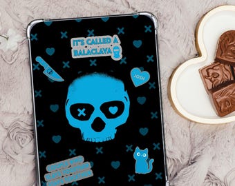 May include: Black tablet case with a blue skull design, hearts, and the text "IT'S CALLED A BALACLAVA". Includes a blue knife, cat, and the name "JOSH".