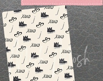 May include: A cream-colored Kindle cover with a repeating pattern of black ice skates, hockey sticks, and hearts, along with the word "xoxo" in a handwritten font. The cover is designed to fit Kindle Paperwhite and Basic models.