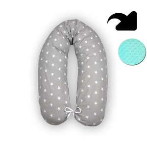 May include: A gray and white U-shaped pregnancy pillow with a white star pattern. The pillow has a white ribbon tie in the center.