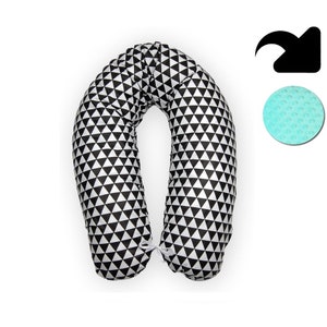 May include: A black and white U-shaped pregnancy pillow with a geometric pattern of triangles. The pillow is made of soft, comfortable fabric and is designed to provide support for pregnant women.