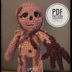 May include: Crochet pattern for a purple and pink amigurumi figure with a creepy, skeletal appearance. The pattern is available as a PDF download. The text "PDF PATTERN ONLY" is visible in a circle on the image. The text "SNOWDROPSANDRAINBOWS" is visible at the bottom of the image.