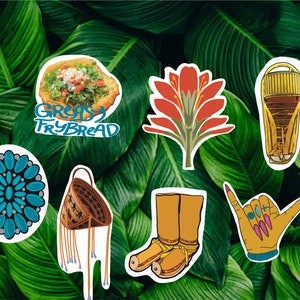 May include: A collection of colorful stickers featuring various designs. Includes a sticker of frybread with text, a turquoise floral design, a woven bag, a red flower, a water tower, a pair of boots, and a hand making a shaka sign.