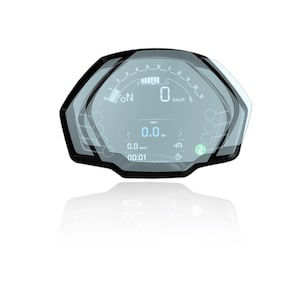 May include: A motorcycle digital dashboard with a black frame and a clear display. The screen shows speed, trip distance, and other data. The speedometer reads 0 km/h. The display has a modern, sleek design.