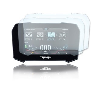 May include: A clear screen protector for a motorcycle dashboard. The protector is designed to fit over the screen and protect it from scratches and damage. The screen protector is shown over a Triumph motorcycle dashboard with a digital display showing the speed, temperature, and other information.